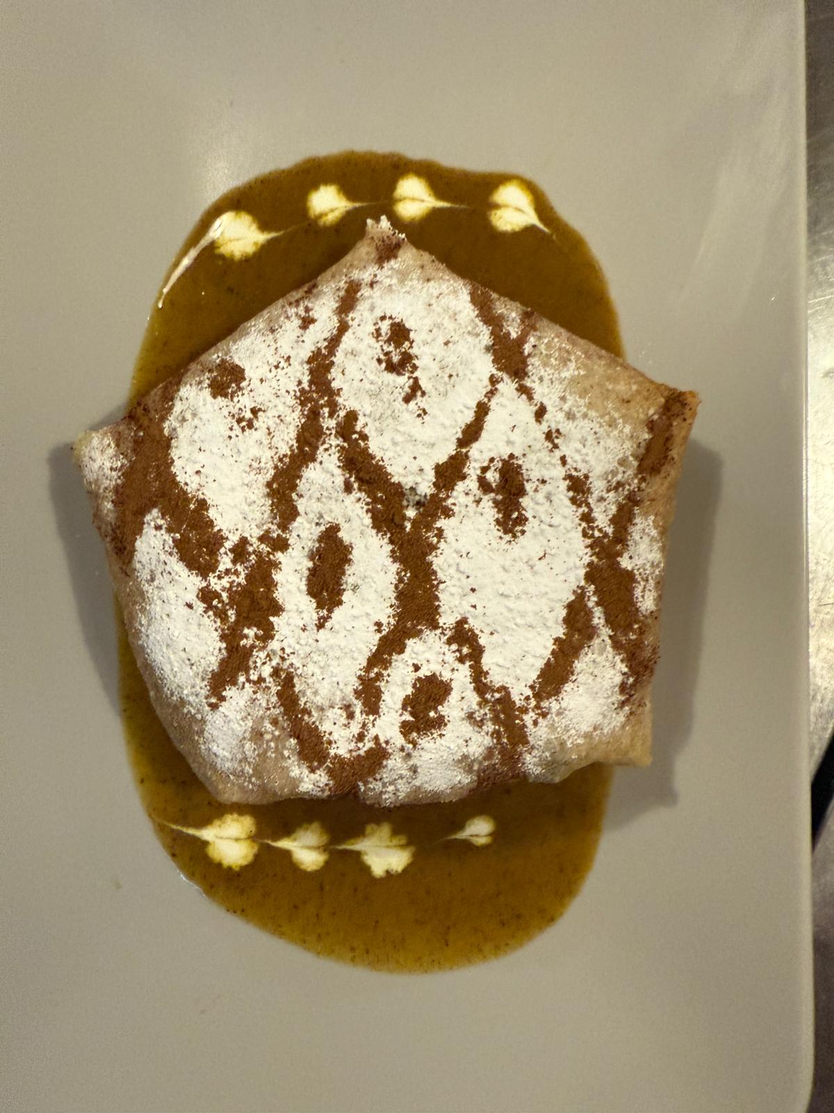 A golden pastry with a patterned dusting at Moorish Lounge