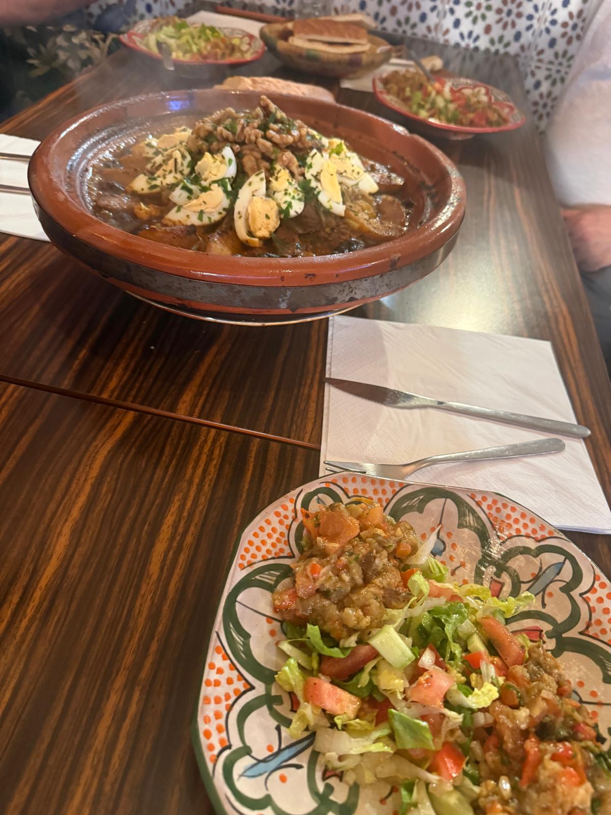 A shared meal in traditional ceramic dishes at Moorish Lounge